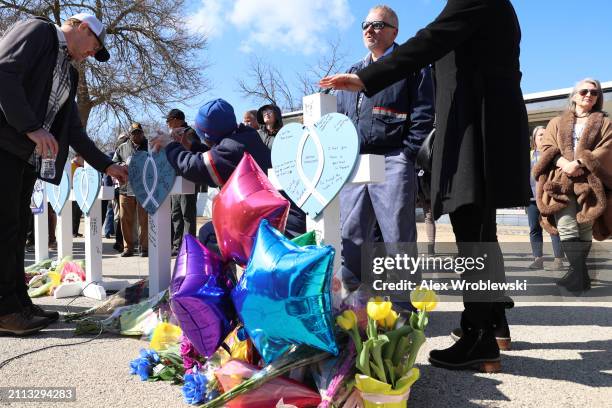 Community members pay their respects at a vigil to remember victims of a recent deadly stabbing attack on March 28, 2024 in Rockford, Illinois. Four...