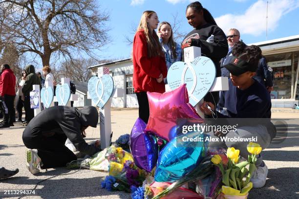 Community members pay their respects at a vigil to remember victims of a recent deadly stabbing attack on March 28, 2024 in Rockford, Illinois. Four...