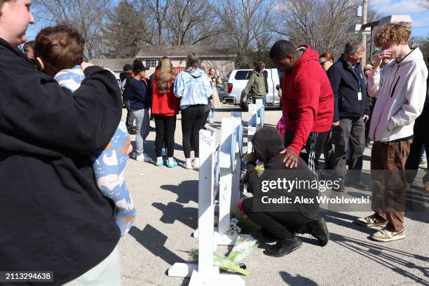 Community members pay their respects at a vigil to remember victims of a recent deadly stabbing attack on March 28, 2024 in Rockford, Illinois. Four...