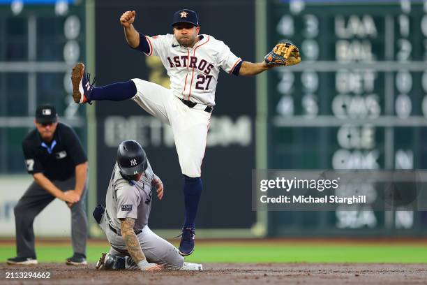 Jose Altuve of the Houston Astros turns a double play during the game between the New York Yankees and the Houston Astros at Minute Maid Park on...