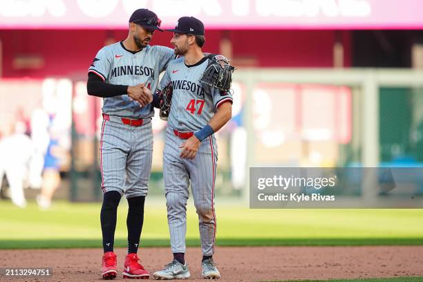 Carlos Correa and Edouard Julien of the Minnesota Twins celebrate their win after the game between the Minnesota Twins and the Kansas City Royals at...