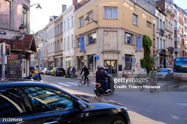 People cross at the intersection between the 'Rue du Trone' and the 'Chaussee de Wavre' on March 28, 2024 in Ixelles, Belgium. Even if the trend is...