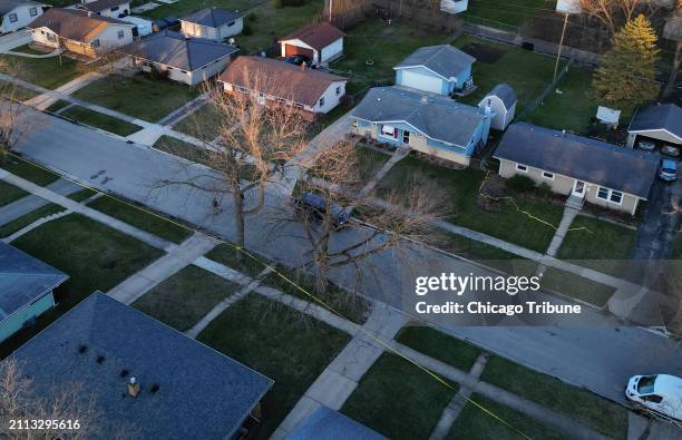 Police tape surrounds several houses as police investigate a mass stabbing along the 2300 block of Holmes Street on March 27 in Rockford, Illinois.