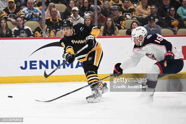 Jack St. Ivany of the Pittsburgh Penguins takes a shot as Brendan Gaunce of the Columbus Blue Jackets defends in the first period during the game at...