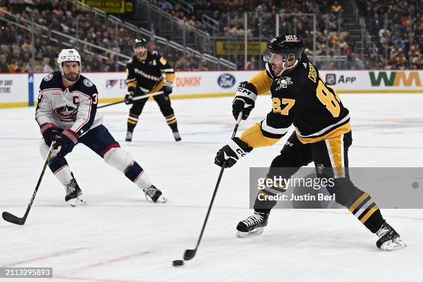 Sidney Crosby of the Pittsburgh Penguins attempts a pass in the first period during the game against the Columbus Blue Jackets at PPG PAINTS Arena on...