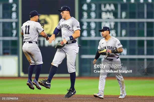 Anthony Volpe, Aaron Judge and Gleyber Torres of the New York Yankees celebrate after the Yankees defeated the Houston Astros at Minute Maid Park on...