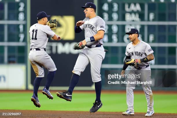 Anthony Volpe, Aaron Judge and Gleyber Torres of the New York Yankees celebrate after the Yankees defeated the Houston Astros at Minute Maid Park on...