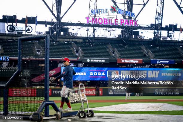 Manager Alex Cora of the Boston Red Sox throws during batting practice before the 2024 Opening Day game against the Seattle Mariners at T-Mobile Park...