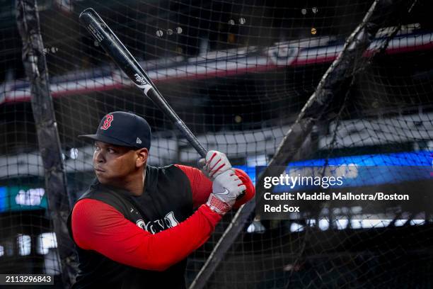 Rafael Devers of the Boston Red Sox takes batting practice before the 2024 Opening Day game against the Seattle Mariners at T-Mobile Park on March...