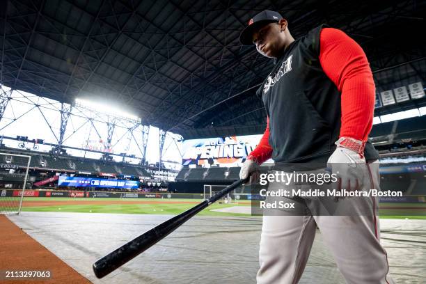 Rafael Devers of the Boston Red Sox takes batting practice before the 2024 Opening Day game against the Seattle Mariners at T-Mobile Park on March...