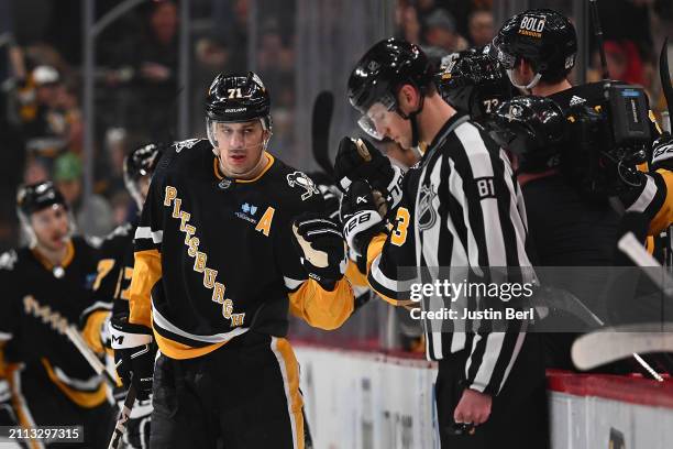 Evgeni Malkin of the Pittsburgh Penguins celebrates with teammates on the bench after scoring a goal in the second period during the game against the...