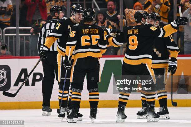 Evgeni Malkin of the Pittsburgh Penguins celebrates with teammates after scoring a goal in the second period during the game against the Columbus...