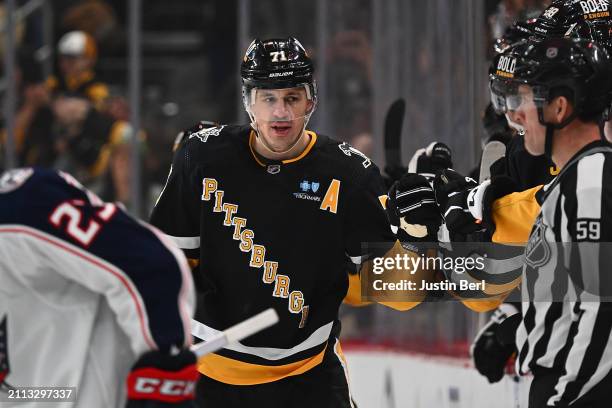 Evgeni Malkin of the Pittsburgh Penguins celebrates with teammates on the bench after scoring a goal in the second period during the game against the...