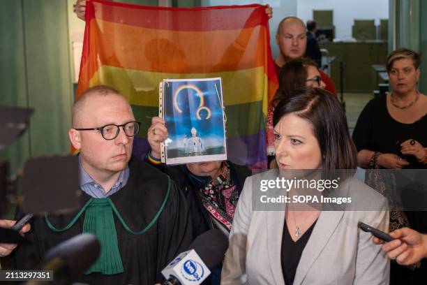 Kaja Godek gives an interview to the press and behind her LGBT activists hold a rainbow flag right after losing the case in the Supreme Court. On...