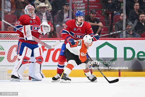 Arber Xhekaj of the Montreal Canadiens defends against Cam Atkinson of the Philadelphia Flyers during the second period at the Bell Centre on March...