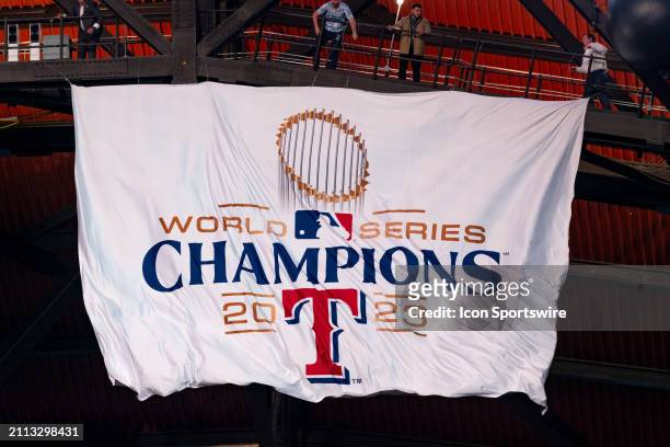 Texas Rangers unveil their 2023 World Series Championship banner before opening day of the 2024 season between the Chicago Cubs and the Texas Rangers...