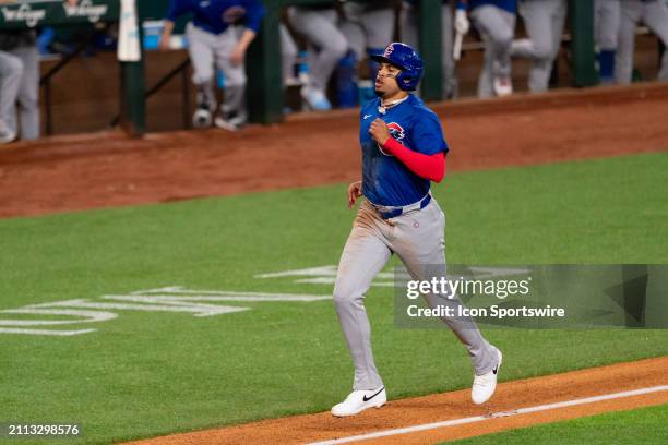 Chicago Cubs second baseman Christopher Morel jogs home to score on a sacrifice fly during opening day of the 2024 season between the Chicago Cubs...