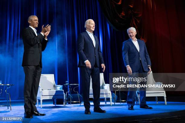 Former US President Barack Obama and former US President Bill Clinton cheer for US President Joe Biden during a campaign fundraising event at Radio...