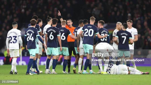 Players from both sides surround referee David Coote during the Premier League match between Tottenham Hotspur and Brentford FC at Tottenham Hotspur...