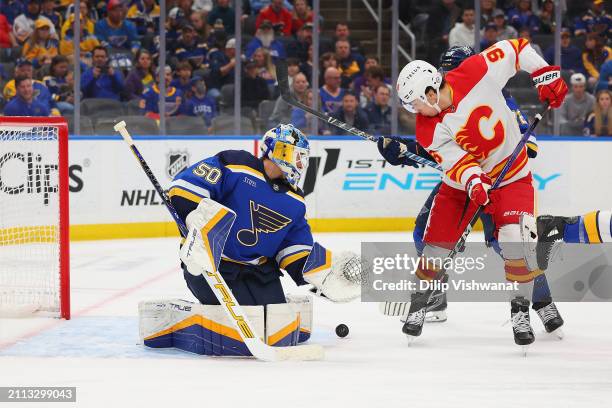 Jordan Binnington of the St. Louis Blues makes a save against Nazem Kadri of the Calgary Flames in the second period at Enterprise Center on March...