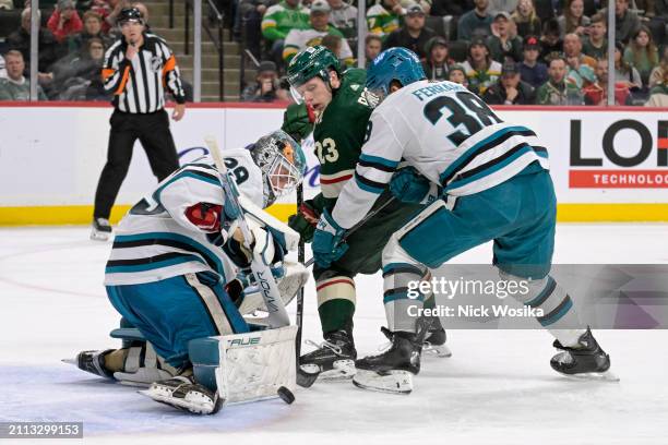 Mackenzie Blackwood of the San Jose Sharks makes a save as Mario Ferraro covers Marco Rossi of the Minnesota Wild during the second period at Excel...