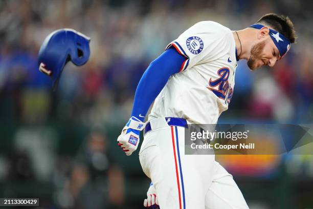 Jonah Heim of the Texas Rangers reacts after hitting a walk off one-run single in the tenth inning to win the game between the Chicago Cubs and the...