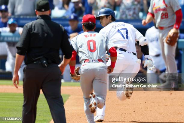 Los Angeles Dodgers designated hitter Shohei Ohtani gets caught in a rundown after trying to stretch a double into a triple in front of St. Louis...