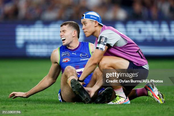 Callum Coleman-Jones of the Kangaroos is seen injured during the 2024 AFL Round 03 match between the North Melbourne Kangaroos and the Carlton Blues...