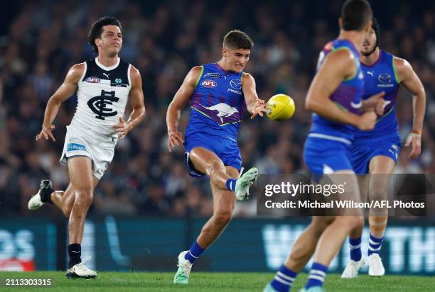 Harry Sheezel of the Kangaroos kicks the ball during the 2024 AFL Round 03 match between the North Melbourne Kangaroos and the Carlton Blues at...