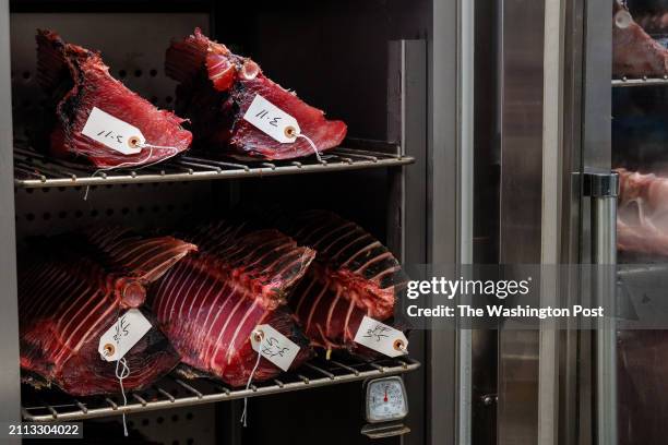 Fresh Yellow Fin Tuna sits above Yellow Fin Tuna that has been aged for two weeks in a dry ager at GW Fins on March 13, 2024 in New Orleans,...