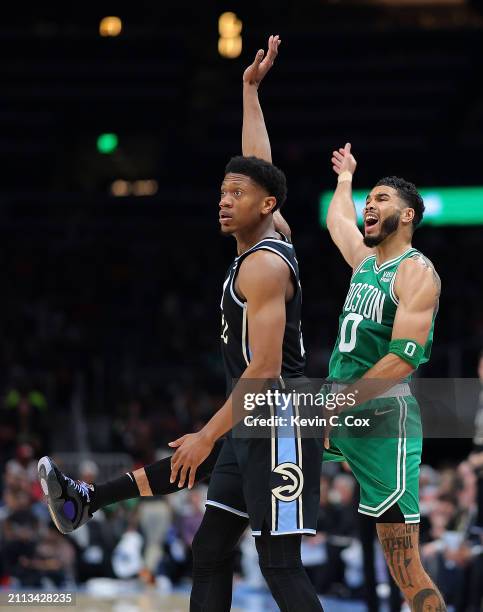 Jayson Tatum of the Boston Celtics reacts as he draws a foul on a three-point basket against De'Andre Hunter of the Atlanta Hawks during the second...