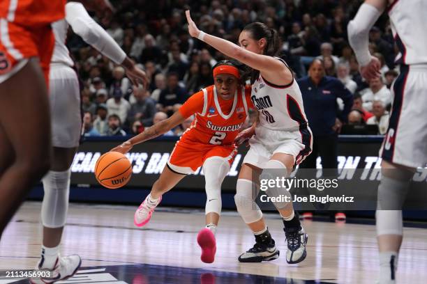 Dyaisha Fair of the Syracuse Orange drives to the rim against Nika Muhl of the Connecticut Huskies during the second half of a second round NCAA...