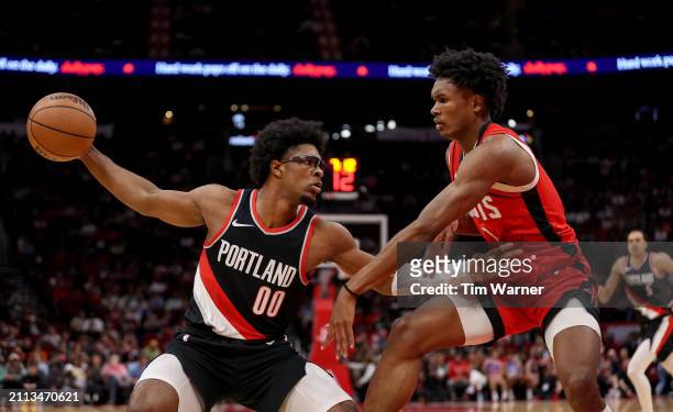 Scoot Henderson of the Portland Trail Blazers controls the ball against Amen Thompson of the Houston Rockets in the first half at Toyota Center on...