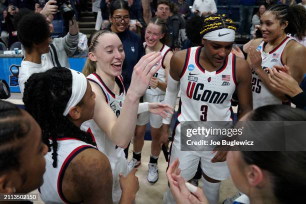 Paige Bueckers and Aaliyah Edwards of the Connecticut Huskies celebrates with their teammates after a second round NCAA Women's Basketball Tournament...