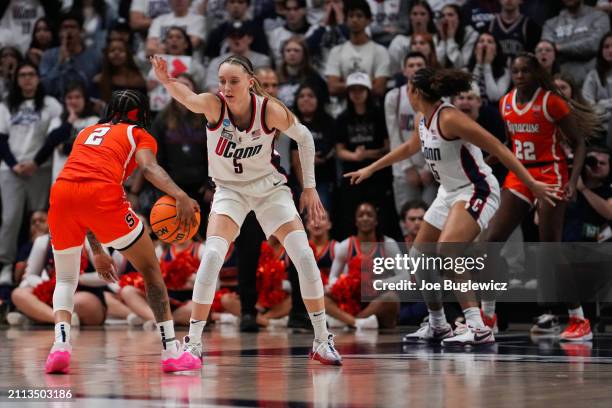 Paige Bueckers of the Connecticut Huskies defends Dyaisha Fair of the Syracuse Orange during the second half of a second round NCAA Women's...