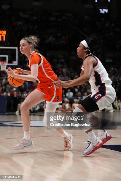 Georgia Woolley of the Syracuse Orange is defended by KK Arnold of the Connecticut Huskies during the first half of a second round NCAA Women's...