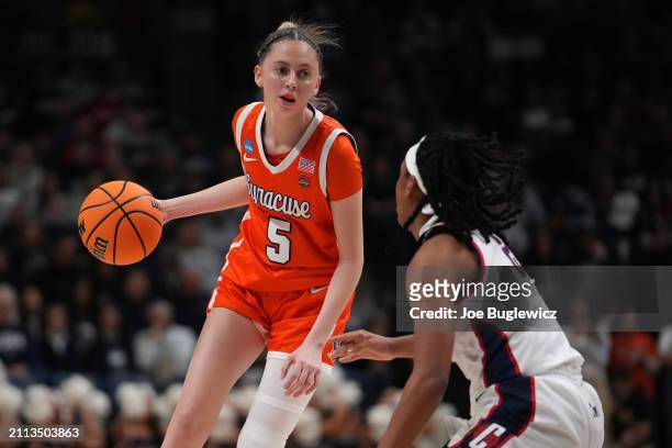 Georgia Woolley of the Syracuse Orange is defended by KK Arnold of the Connecticut Huskies during the first half of a second round NCAA Women's...