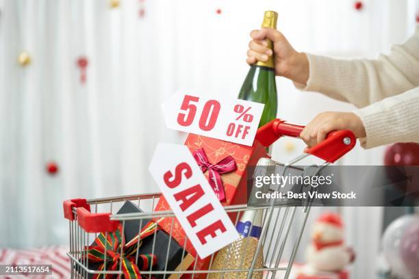 the young woman pushing a shopping cart - hand shopping bag stock pictures, royalty-free photos & images