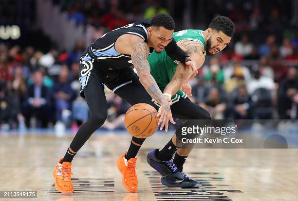 Dejounte Murray of the Atlanta Hawks draws a foul from Jayson Tatum of the Boston Celtics during the fourth quarter at State Farm Arena on March 25,...