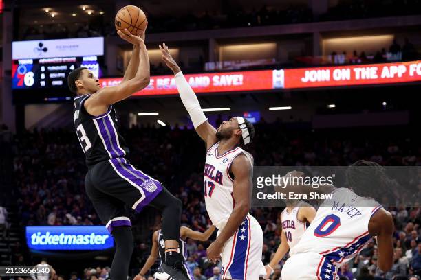 Keegan Murray of the Sacramento Kings shoots over Buddy Hield of the Philadelphia 76ers in the first half at Golden 1 Center on March 25, 2024 in...
