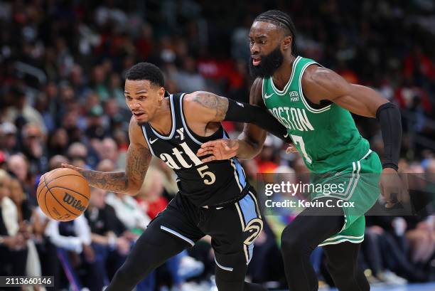 Dejounte Murray of the Atlanta Hawks drives against Jaylen Brown of the Boston Celtics during the third quarter at State Farm Arena on March 25, 2024...