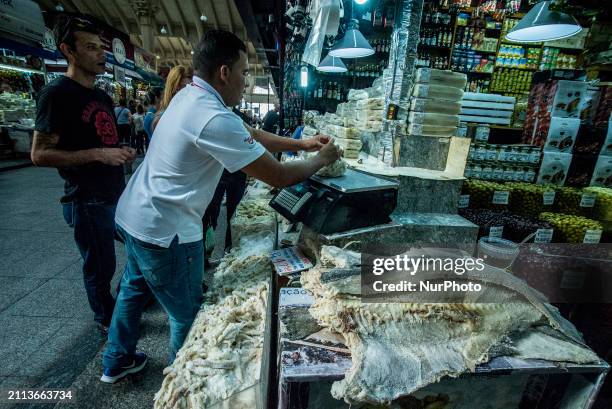People are searching for fish at the Municipal Market on the eve of Good Friday in Sao Paulo, Brazil, on March 28, 2024.