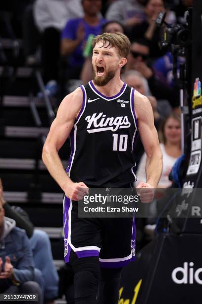 Domantas Sabonis of the Sacramento Kings reacts after the Kings made a basket against the Philadelphia 76ers at Golden 1 Center on March 25, 2024 in...