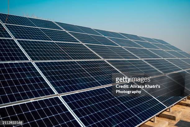 clean energy:  solar panels in sunlight - islamabad stock pictures, royalty-free photos & images