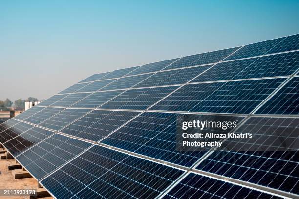 clean energy:  solar panels in sunlight - islamabad stock pictures, royalty-free photos & images