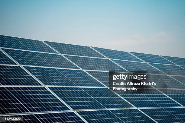 clean energy:  solar panels in sunlight - islamabad stock pictures, royalty-free photos & images