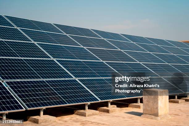 clean energy:  solar panels in sunlight - islamabad stock pictures, royalty-free photos & images