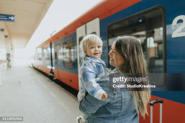 smiling baby boy going on a journey - family public transportation stock pictures, royalty-free photos & images