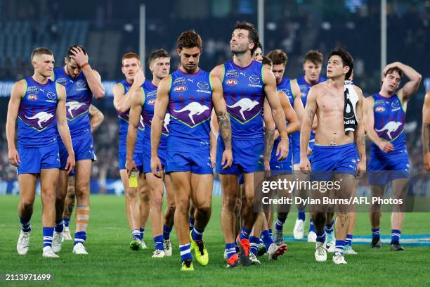 North Melbourne players look dejected as they leave the field during the 2024 AFL Round 03 match between the North Melbourne Kangaroos and the...