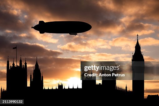 Blimp above Big Ben and Westminster Bridge in London at sunset